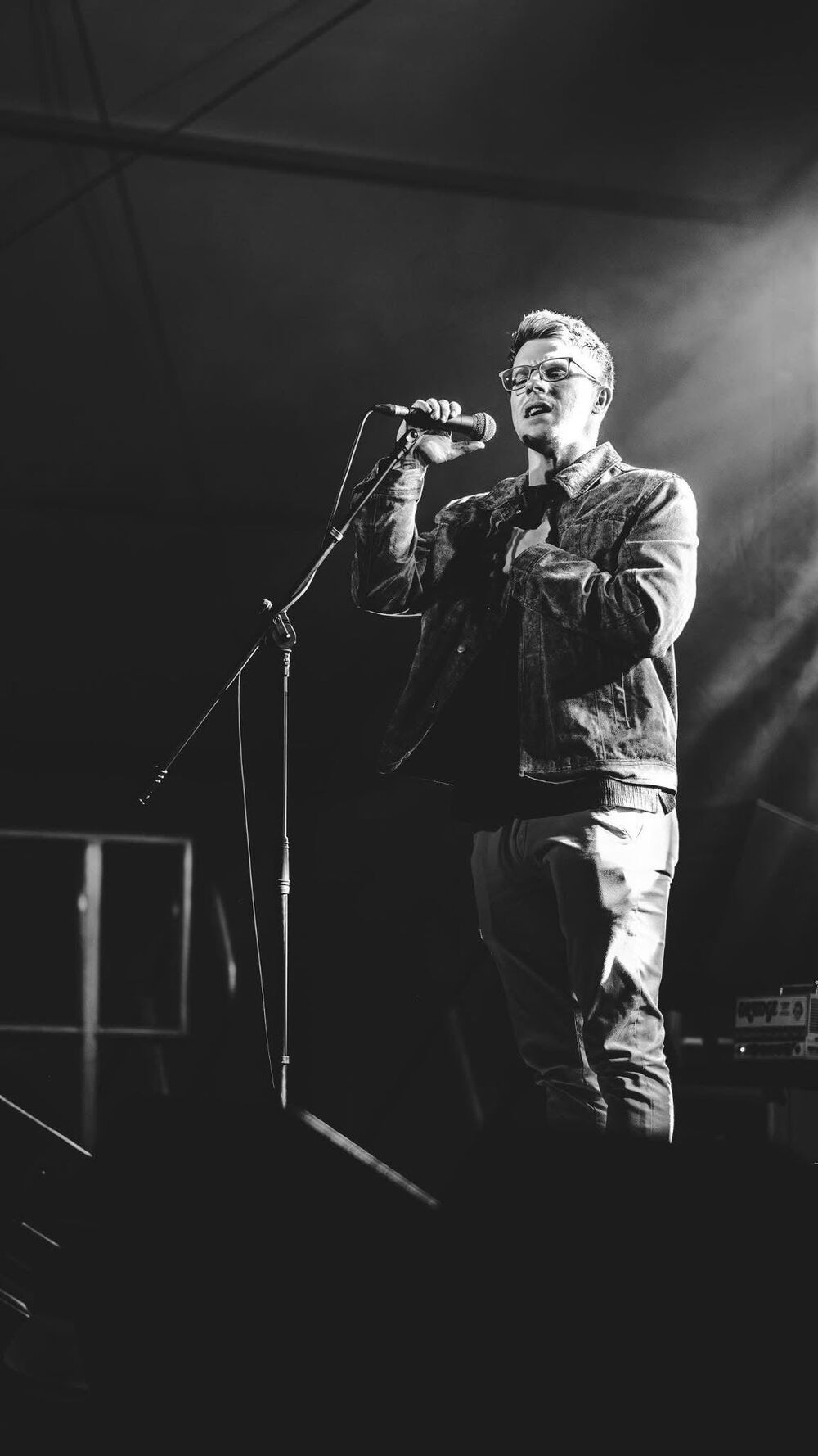 Nathan Grisdale performing live under stage lighting